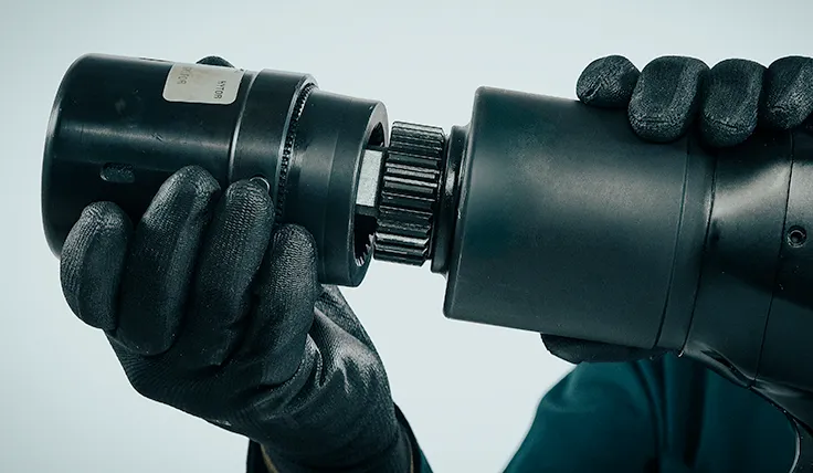 A gloved hand attaches the HYTORC Washer Driver to the jGun Digital Speed pneumatic torque tool