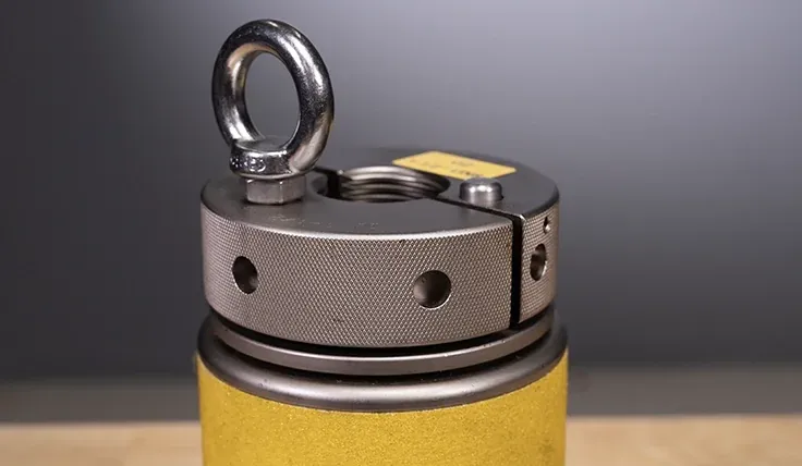 Subsea tensioner with lifting eye bolt and split reaction nut